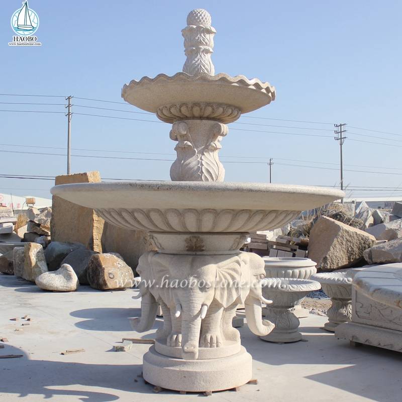 象の彫刻を施した庭の装飾大理石の水車の噴水
